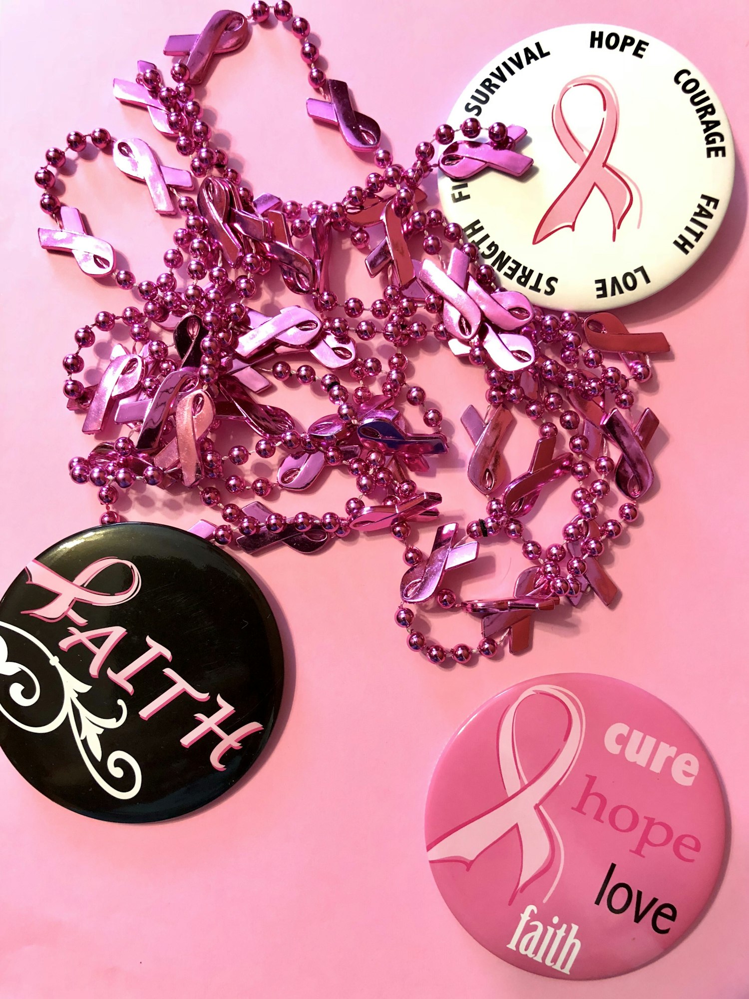 Pins and necklaces in support for breast cancer awareness month.